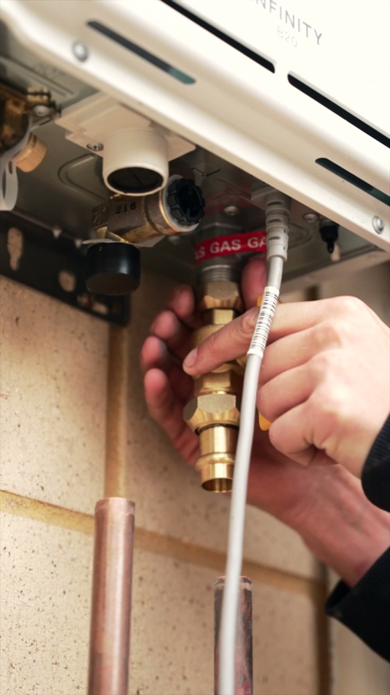 Gas and water fittings on a hot water system