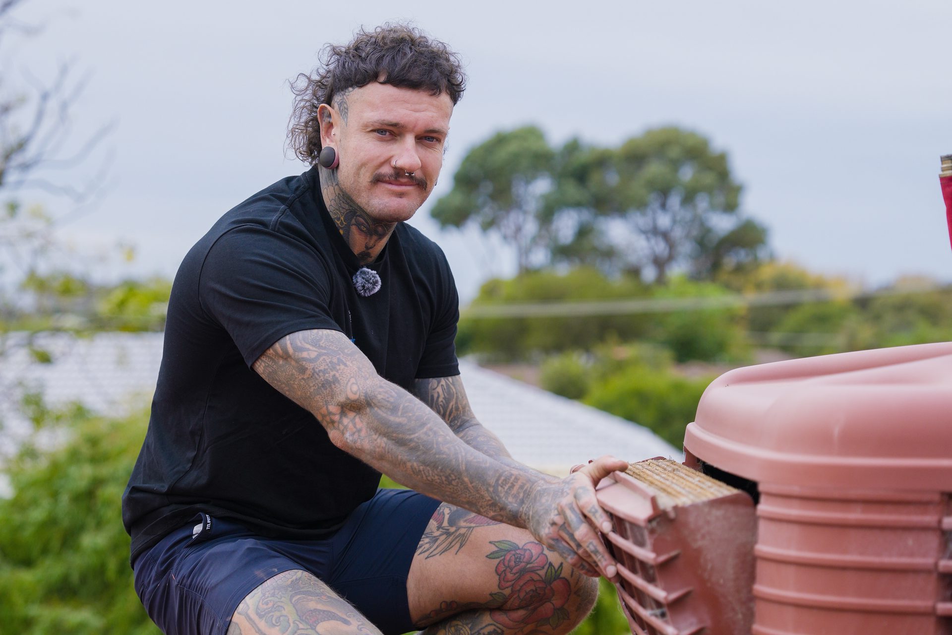 Ruben Bird repairing a rooftop evaporative cooler