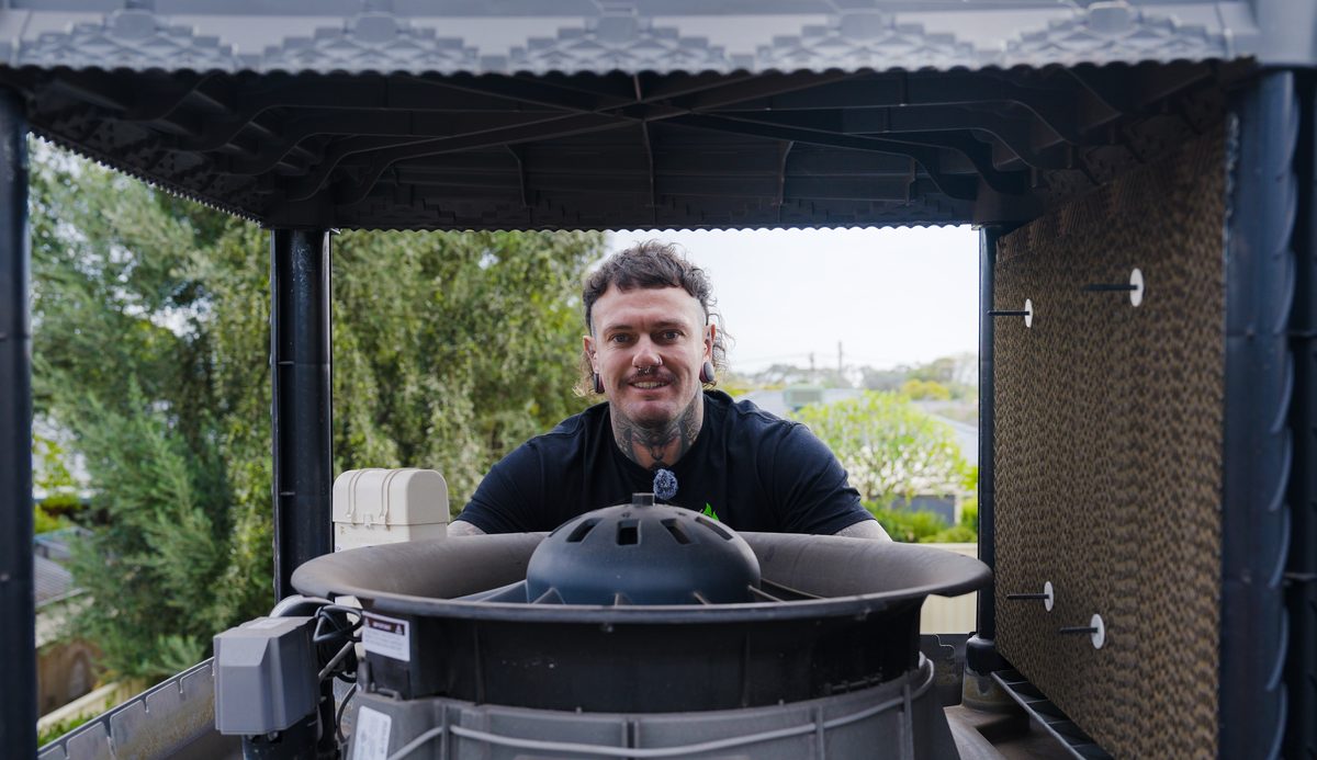 Ruben Bird from Birdy's servicing an evaporative cooler on the roof